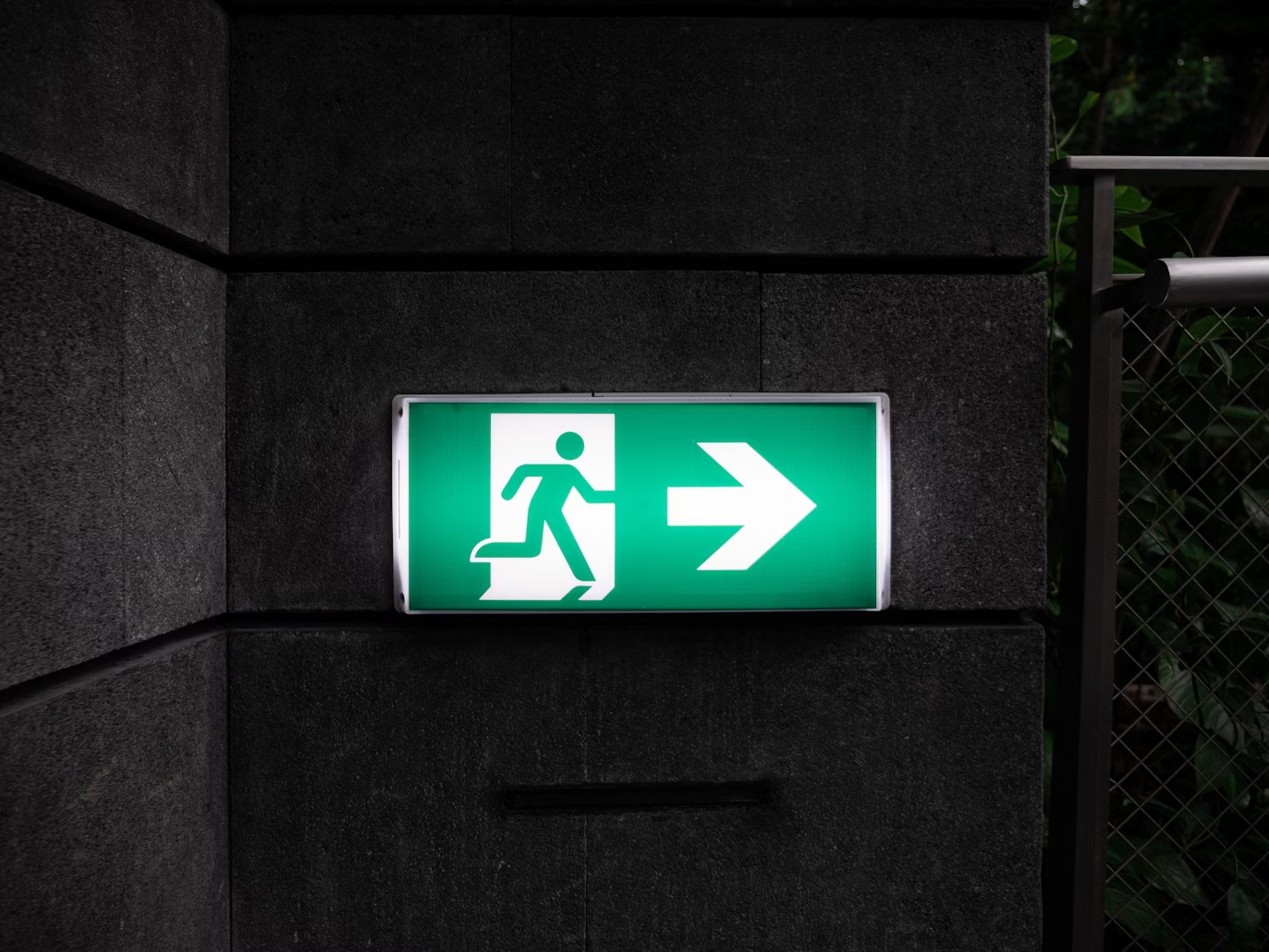An exit sign illuminating a safe pathway 